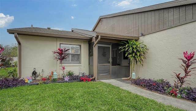 doorway to property with a lawn