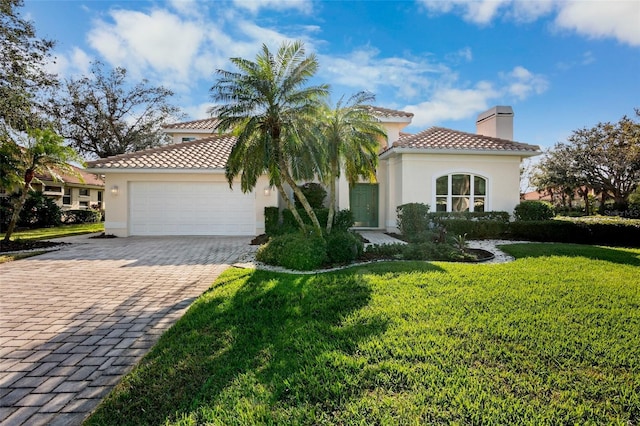 mediterranean / spanish-style house featuring a front lawn and a garage