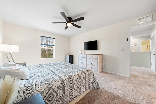 bedroom with ceiling fan and light colored carpet