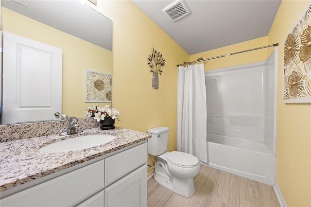 full bathroom featuring hardwood / wood-style floors, toilet, shower / tub combo, and vanity