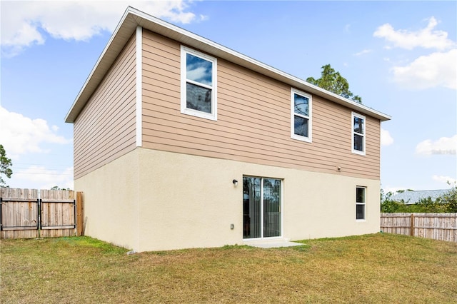 rear view of house with a yard