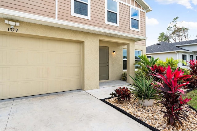 doorway to property with a garage