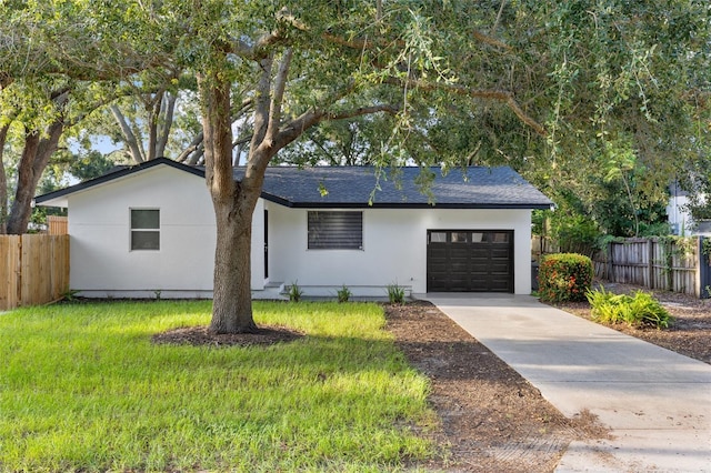 view of front of property with a garage and a front yard