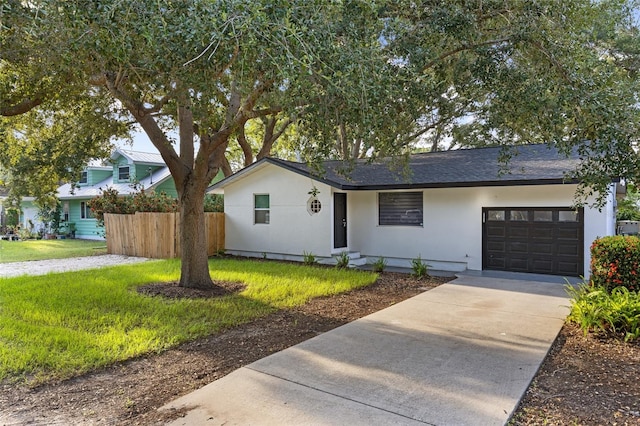 view of front of home featuring a front lawn and a garage