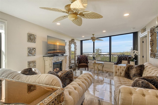 living room featuring marble finish floor, recessed lighting, ceiling fan, and a high end fireplace