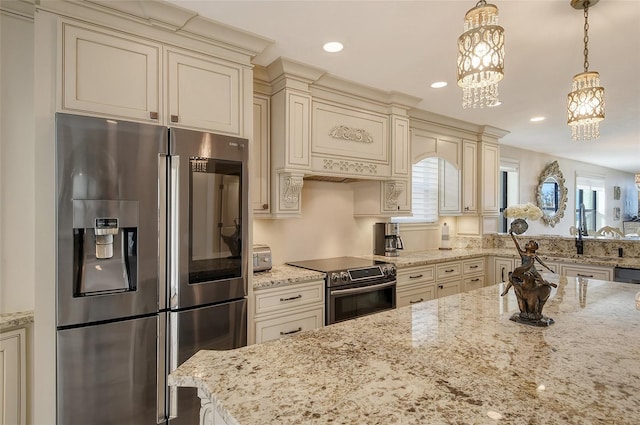 kitchen with light stone counters, decorative light fixtures, recessed lighting, cream cabinets, and appliances with stainless steel finishes