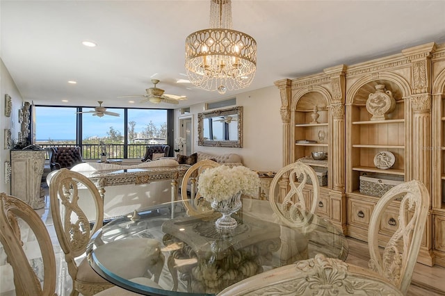 dining room featuring ceiling fan with notable chandelier and recessed lighting