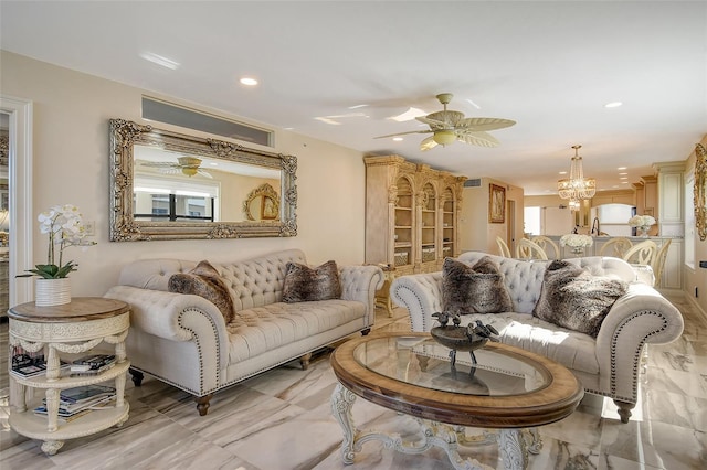 living room with marble finish floor, recessed lighting, and ceiling fan with notable chandelier