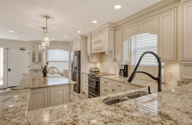 kitchen featuring cream cabinets, a sink, double oven range, fridge with ice dispenser, and light stone countertops