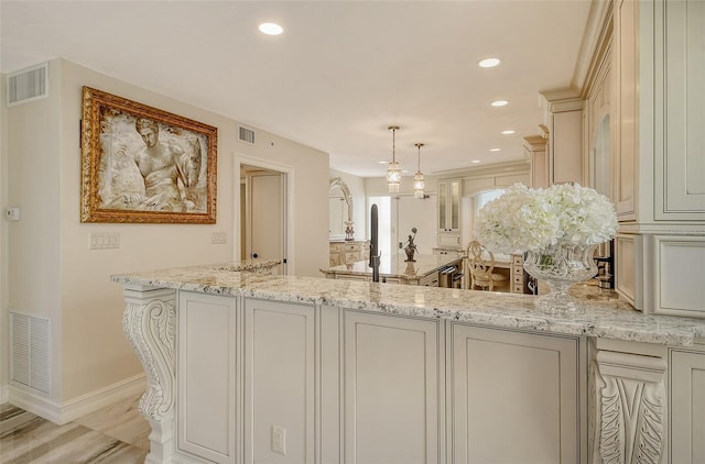 kitchen with visible vents, light stone counters, and recessed lighting