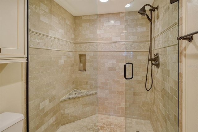 full bath with a stall shower and toilet