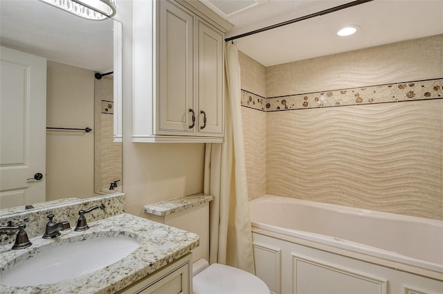 bathroom featuring toilet, visible vents, shower / bath combo with shower curtain, and vanity