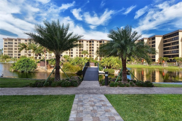 view of home's community featuring a water view and a yard