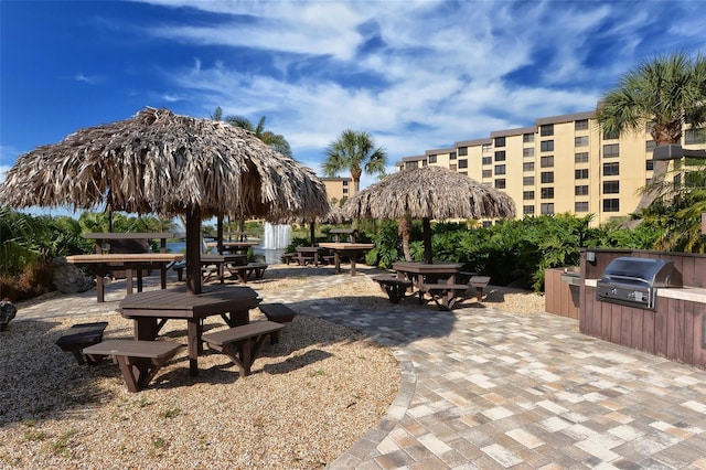 view of community featuring an outdoor kitchen, a patio area, and outdoor dining area