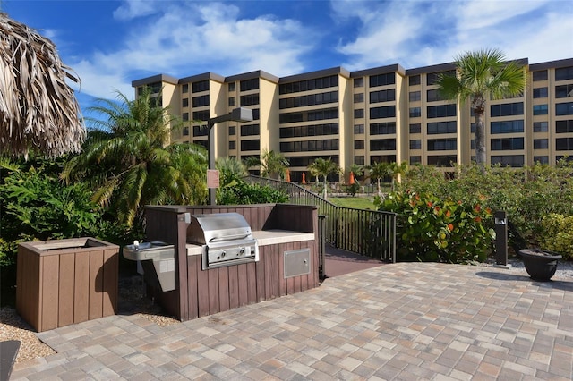 view of patio / terrace featuring an outdoor kitchen, a grill, and fence