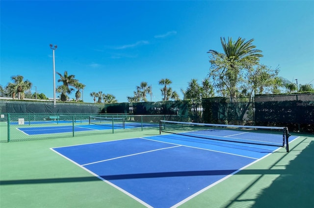 view of sport court with fence