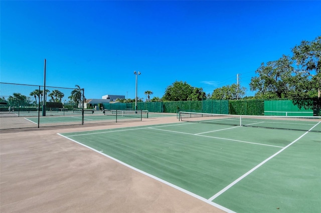 view of tennis court with fence