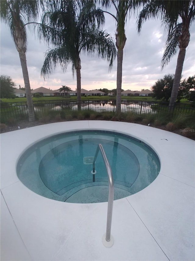 pool at dusk with a water view