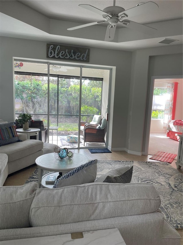 living room featuring ceiling fan and tile patterned floors