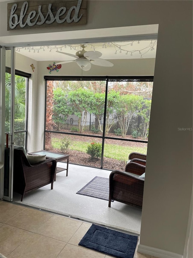 sunroom / solarium featuring ceiling fan