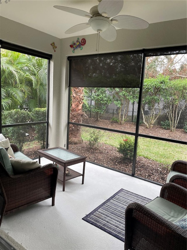 sunroom with ceiling fan and vaulted ceiling