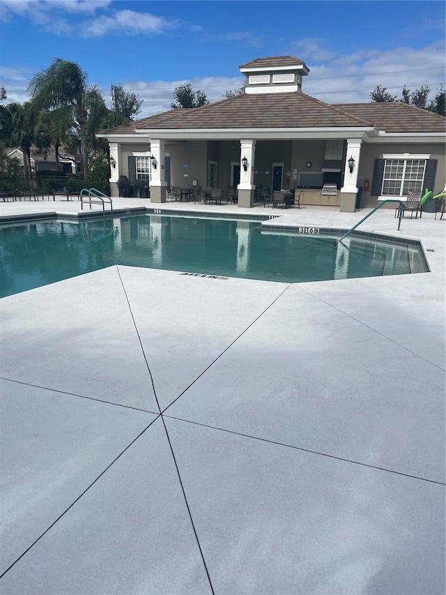 view of swimming pool featuring a patio area