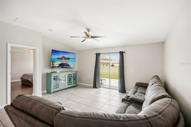 living room with ceiling fan, light tile patterned floors, and vaulted ceiling