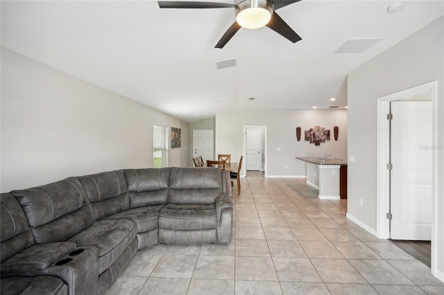 tiled living room featuring ceiling fan