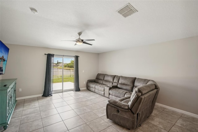 tiled living room featuring ceiling fan