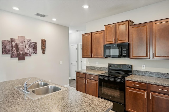 kitchen with sink and black appliances