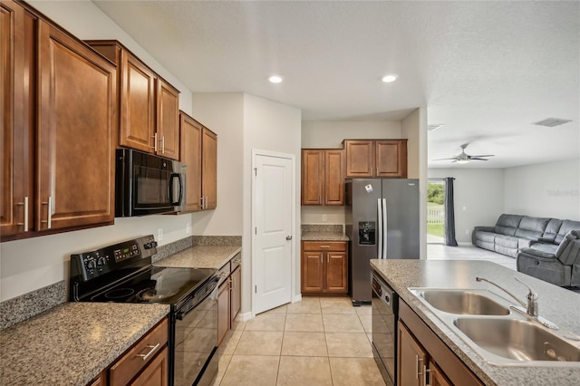 kitchen featuring ceiling fan, light tile patterned floors, sink, and black appliances