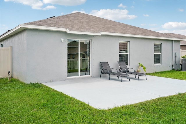 back of property featuring a patio area and a yard