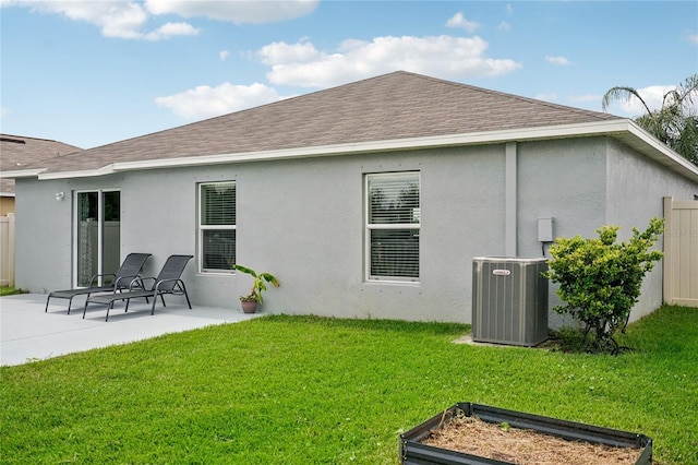 back of property featuring a patio area, a yard, and central air condition unit