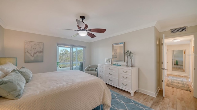 bedroom featuring ornamental molding, ceiling fan, and light wood-type flooring