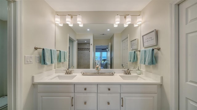 bathroom with walk in shower and vanity