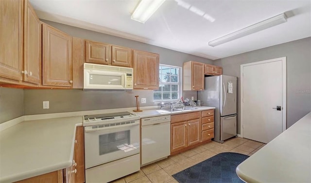 kitchen featuring light tile patterned flooring, sink, light brown cabinets, and white appliances