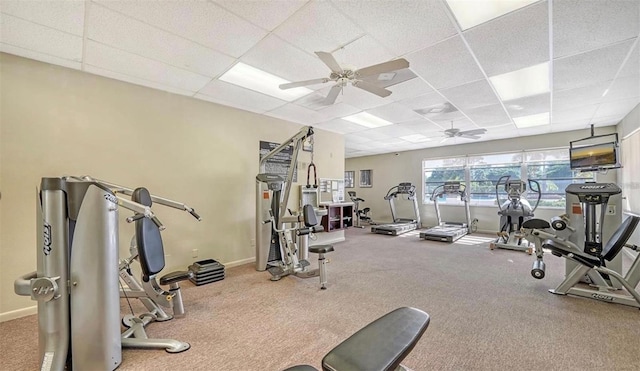 exercise room featuring ceiling fan and a drop ceiling