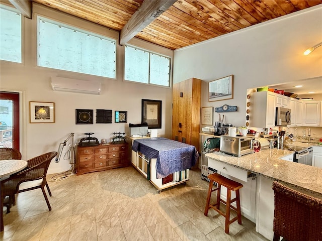 bedroom with a towering ceiling, beamed ceiling, wood ceiling, and a wall mounted air conditioner