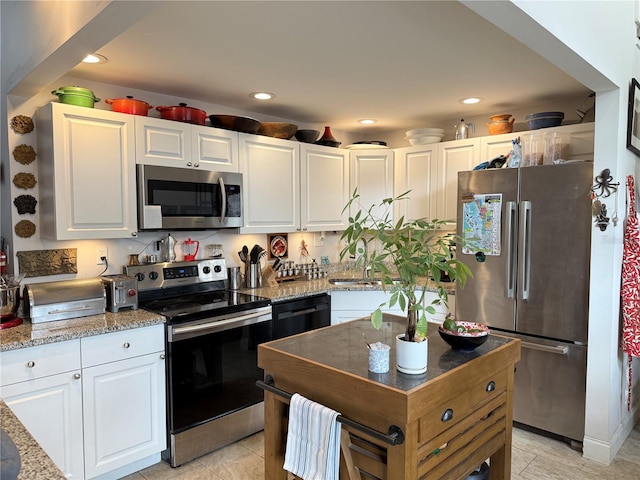 kitchen featuring appliances with stainless steel finishes, sink, and white cabinetry