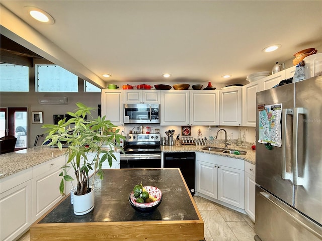 kitchen featuring sink, light tile patterned flooring, stainless steel appliances, white cabinets, and light stone counters