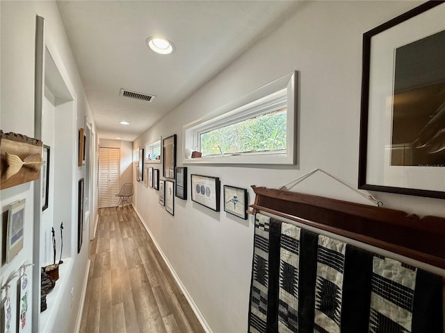 corridor featuring wood-type flooring