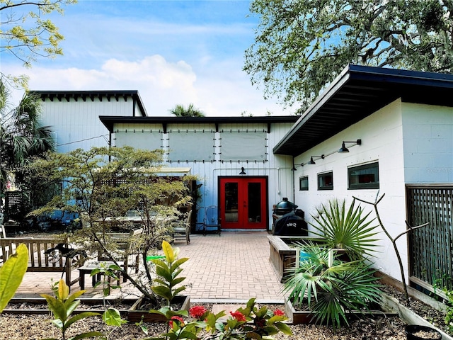 rear view of property featuring french doors and a patio