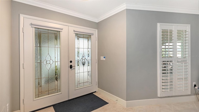 tiled foyer entrance featuring french doors and crown molding