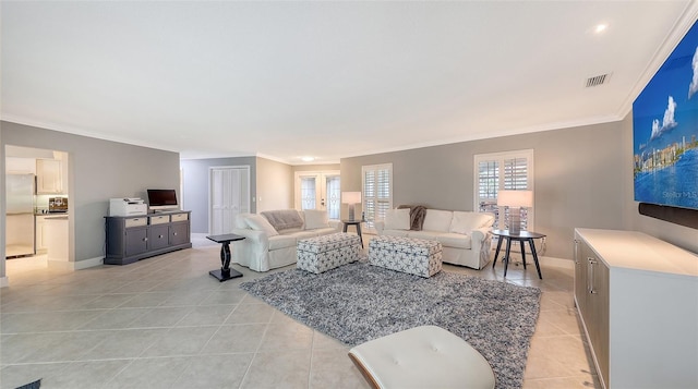 tiled living room with french doors and ornamental molding