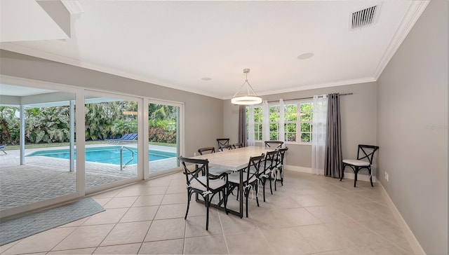 dining space featuring light tile patterned floors and crown molding