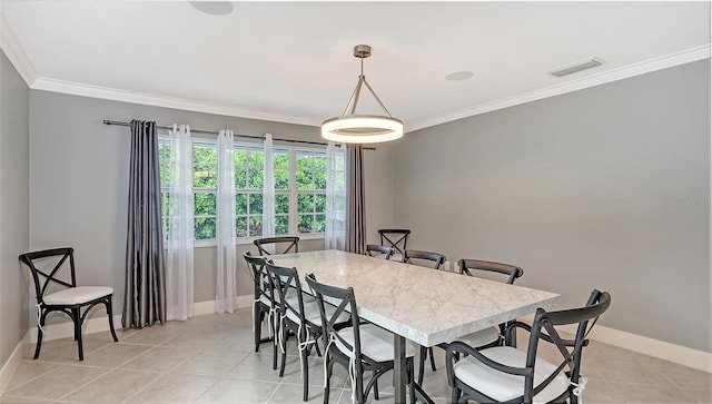 tiled dining room featuring ornamental molding