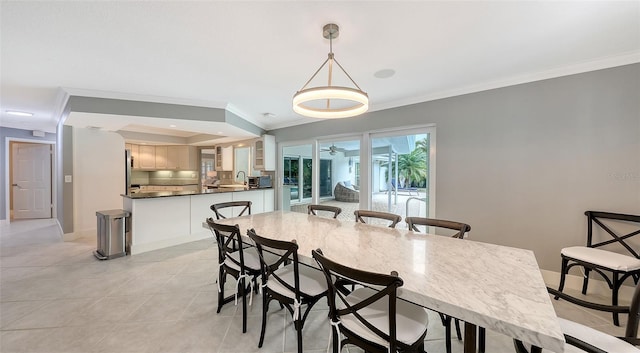 dining area with light tile patterned floors and crown molding