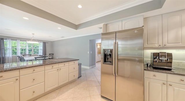 kitchen featuring stainless steel fridge with ice dispenser, dark stone countertops, ornamental molding, and light tile patterned flooring