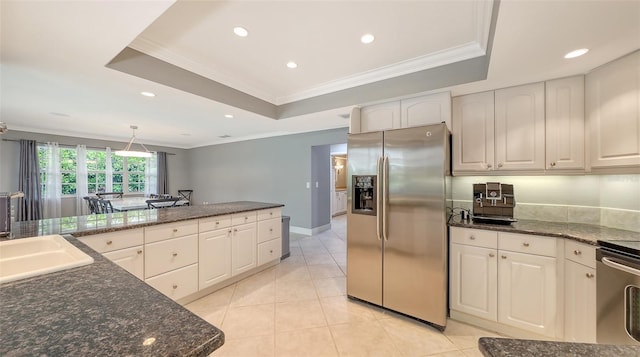 kitchen with stainless steel refrigerator with ice dispenser, crown molding, and a raised ceiling