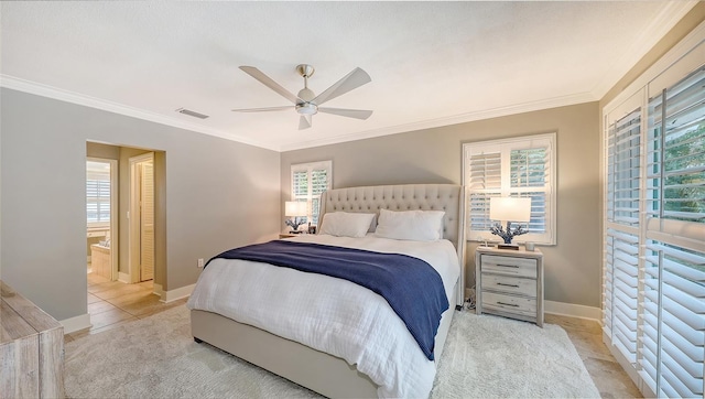 tiled bedroom with ceiling fan, multiple windows, ensuite bathroom, and ornamental molding